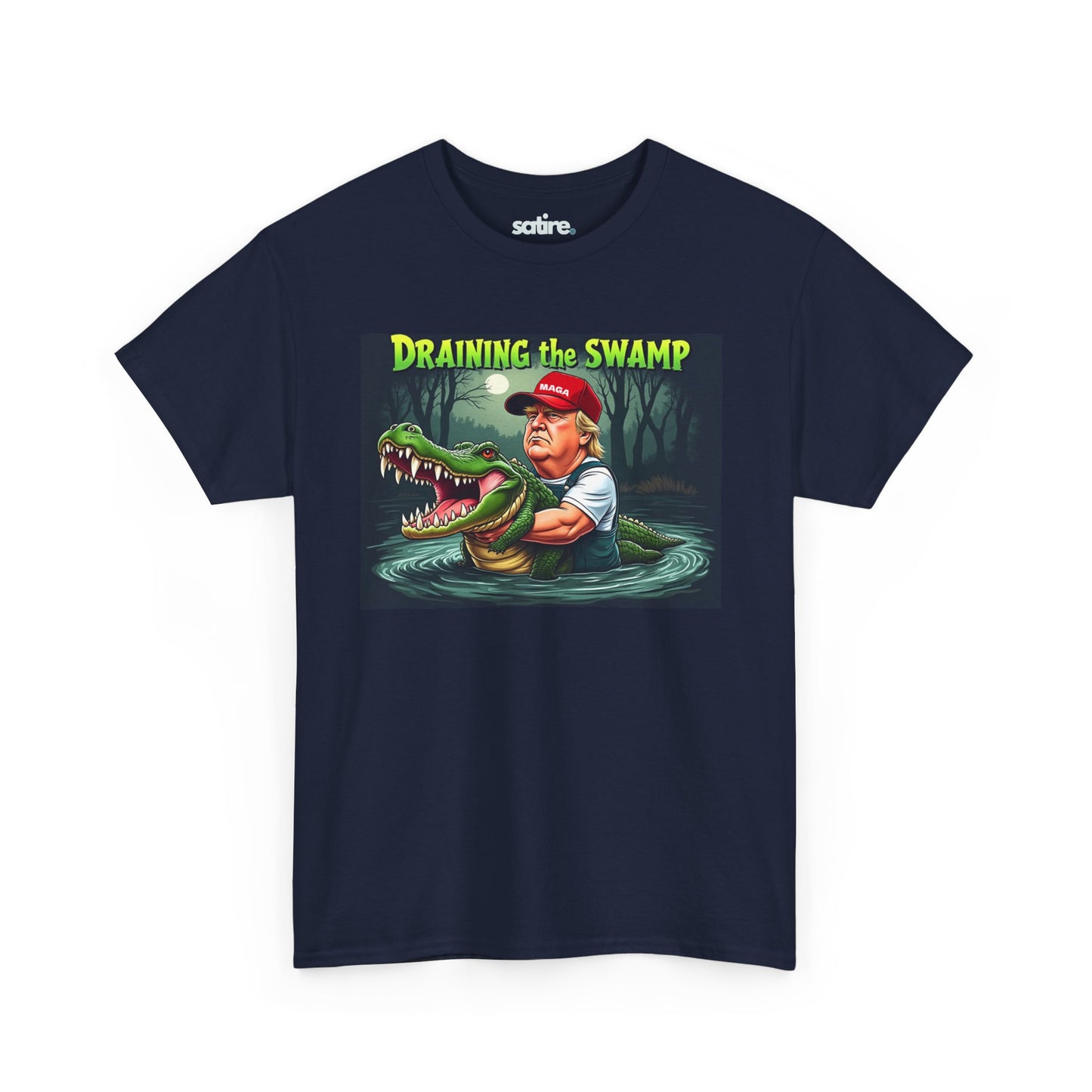 Navy blue t-shirt with a graphic design featuring a cartoon Donald Trump in waders holding a large alligator in a swamp under a full moon, with the text 'DRAINING THE SWAMP' above in bold yellow and green letters. | Satire Clothes