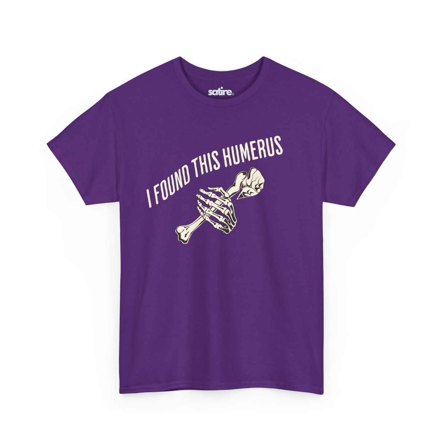 Purple t-shirt with the text 'I FOUND THIS HUMERUS' printed in white. Below the text, there's an illustration of a skeletal hand holding a humerus bone. | Satire Clothes