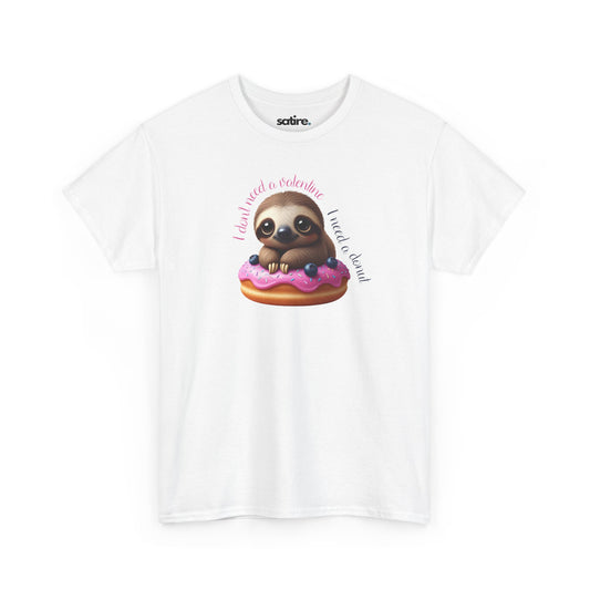 White t-shirt with a cartoon sloth sitting on a pink frosted donut with blueberries. The text around the sloth reads 'I don't need a valentine, I need a donut' in a playful font. | Satire Clothes