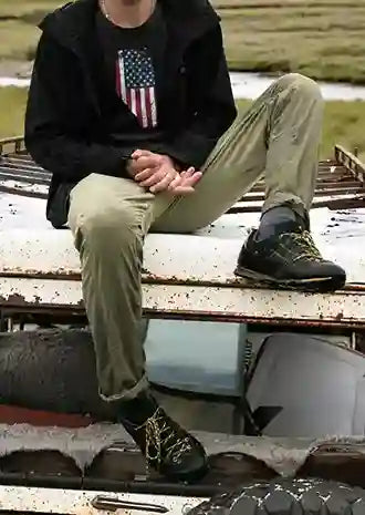 A man wearing a black T-shirt with a graphic of Alberta's silhouette filled with the design of the American flag | Satire Clothes