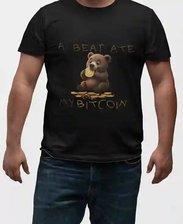 Man wearing a black t-shirt with a cartoon bear eating a Bitcoin, text reads "A BEAR ATE MY BITCOIN" with Bitcoin symbols around the bear.  | Satire Clothes