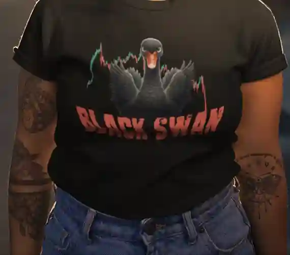 A woman wearing a black t-shirt featuring a graphic of a menacing black swan with stock market graphs in the background. The text on the shirt reads "BLACK SWAN" in bold red letters. She is also wearing blue jeans and has visible tattoos on her arms.