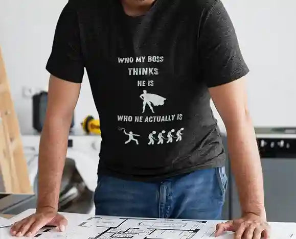 Man wearing black satirical t-shirt with 'WHO MY BOSS THINKS HE IS' above a super hero silhouette, and 'WHO HE ACTUALLY IS' above a person whipping others | Satire Clothes