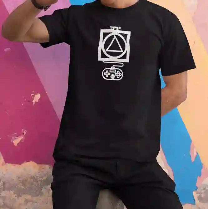 Man wearing a black t-shirt with a white graphic design featuring a triangle inside a circle, which is inside a square, with a game controller below. | Satire Clothes