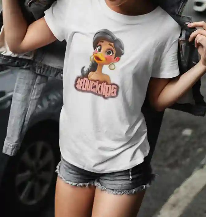 Woman wearing a white t-shirt with a humorous graphic of a character with a duck's beak and the text "#Ducklips" in bold, pink letters | Satire Clothes