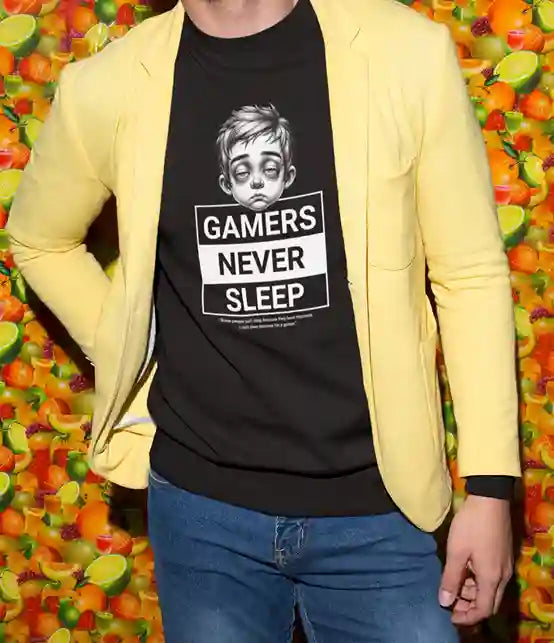 Man wearing a black T-Shirt with an illustration of a tired looking person with the text "Gamers Never Sleep" in bold white and black blocks underneath. | Satire Clothes