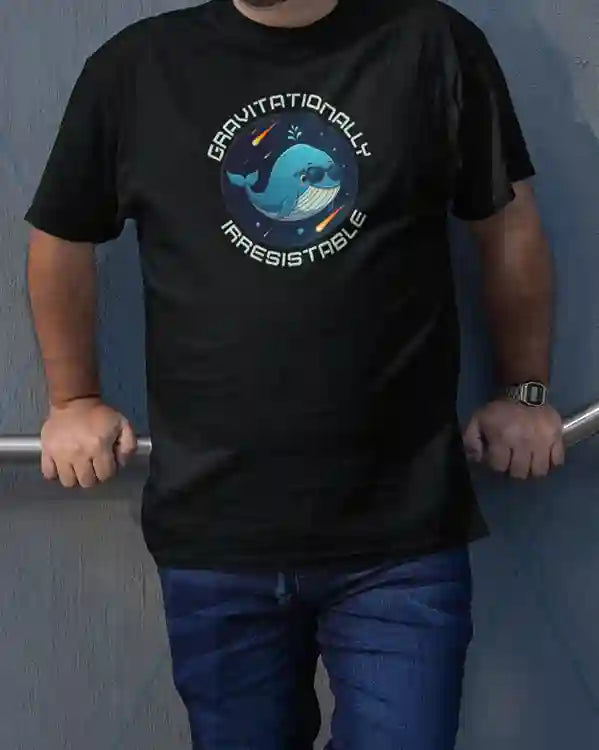 Man wearing black t-shirt featuring a space whale wearing sunglasses, surrounded by a circular text that reads 'GRAVITATIONALLY IRRESISTIBLE' | Satire Clothes