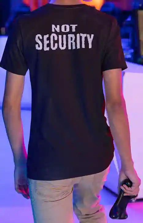 Man wearing a black t-shirt with "NOT SECURITY" printed on the back.