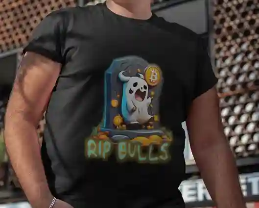 A plus sized man wearing a black t-shirt with a cartoon ghost emerging from a tombstone, holding a Bitcoin symbol. The ghost is surrounded by small Bitcoin icons and the text "RIP BULLS" is glowing below in green and blue | Satire Clothes.