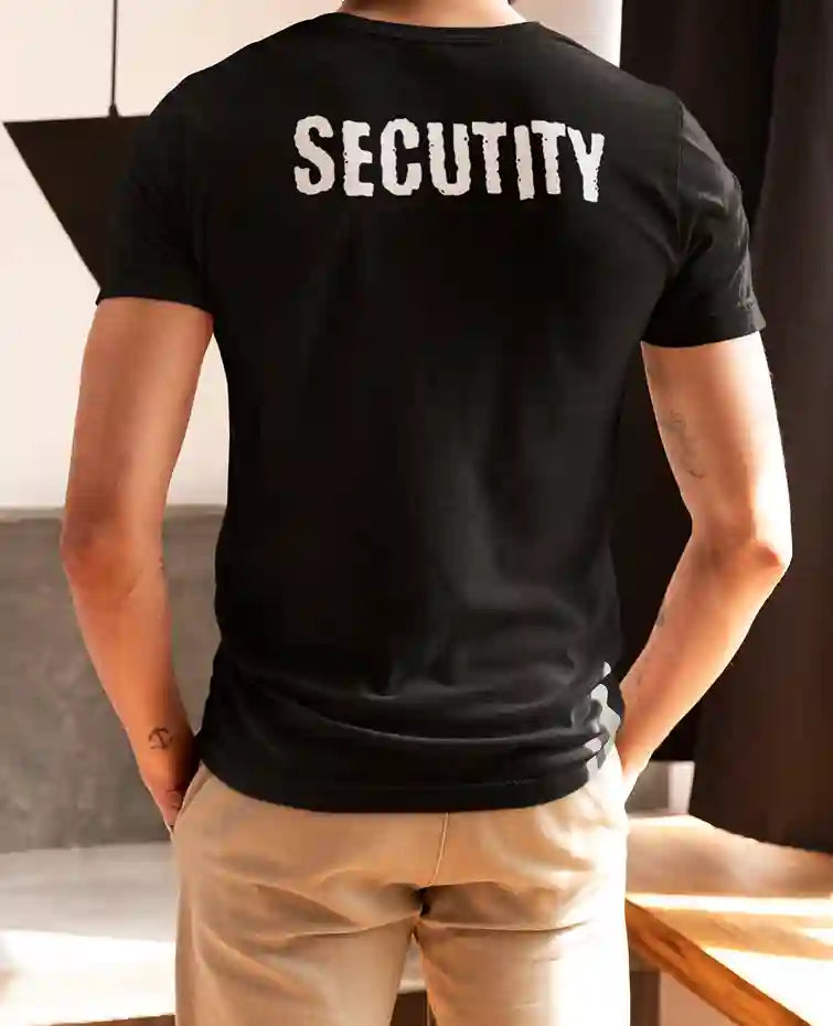 Man wearing a black T-Shirt with humorous 'SECUTITY' print on the back | Satire Clothes