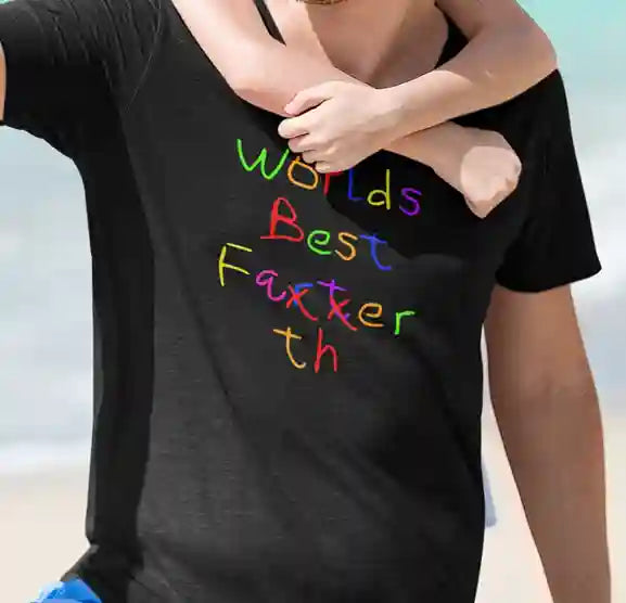 A man wearing a black t-shirt with the text "Worlds Best" followed by "Farter" crossed out and corrected to "Father" with "th" added in a playful, colorful font | Satire Clothes